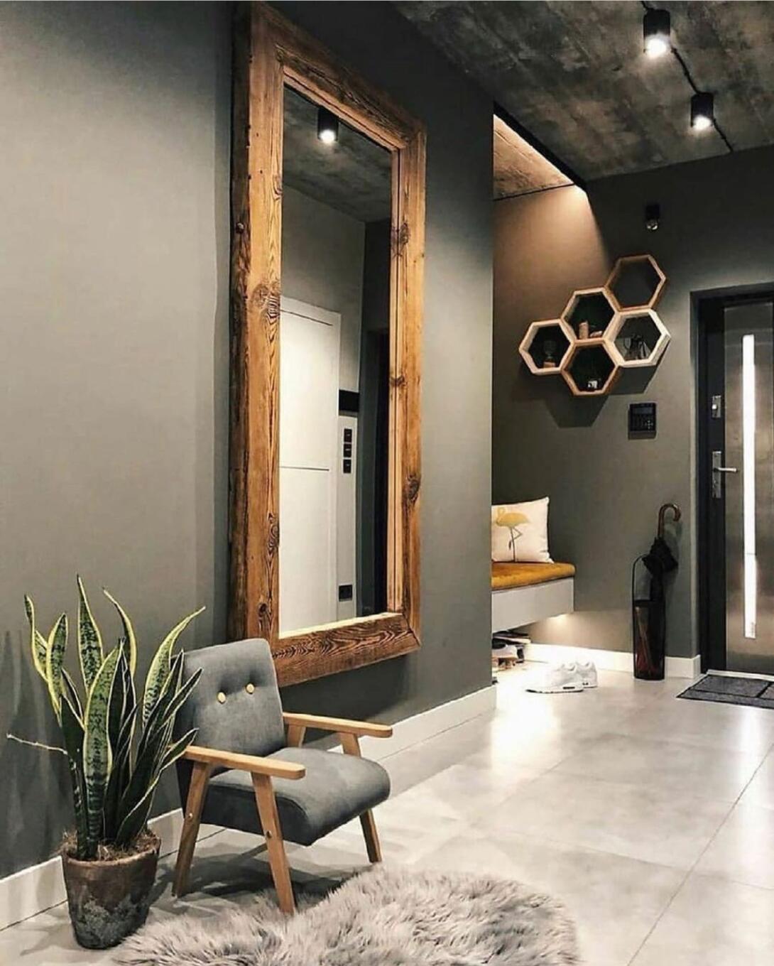 Een brede passpiegel hangend aan de muur